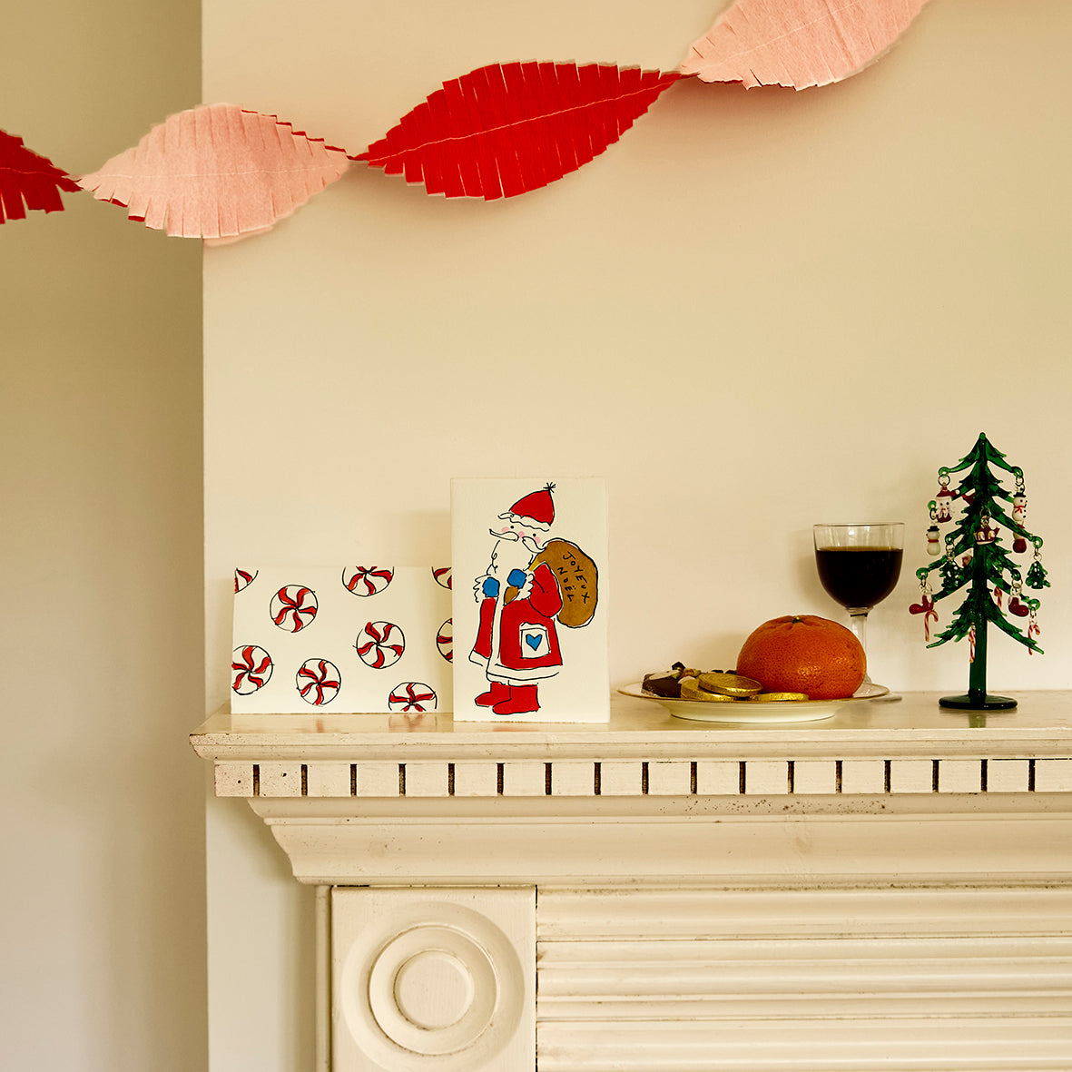 Two Christmas cards by Scribble & Daub on a mantelpiece, Santa Claus and Christmas Candies