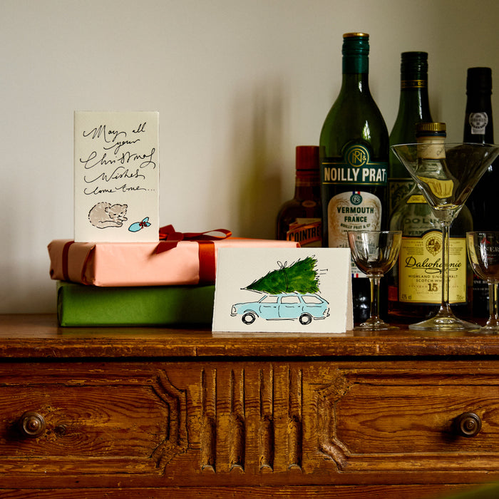 Two Christmas cards by Scribble & Daub on a mantelpiece, Santa Claus and Christmas Candies